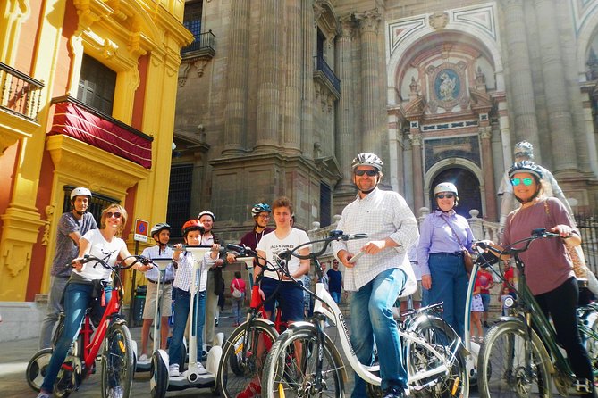 Malaga Electric Bikes Guided Tour - Alcazaba walls down to the sea: port light, Muelle Uno, and Palmeral de las Sorpresas